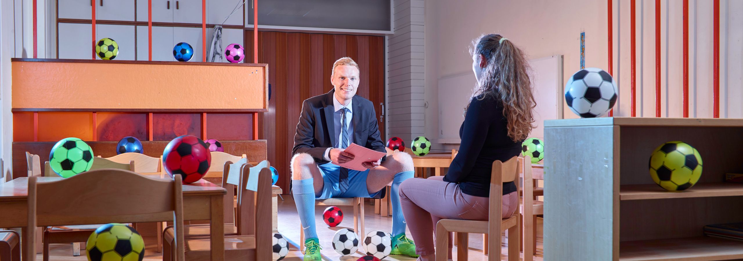 Mann mit Fußballkleidung in einer Kindertagesstätte