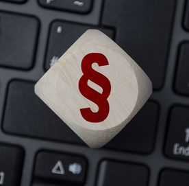 W&uuml;rfel auf Tastatur mit Paragraphen-Symbol